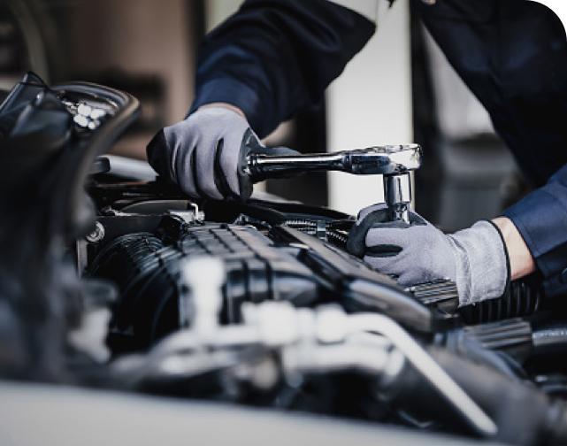 wrench being used to work on an engine